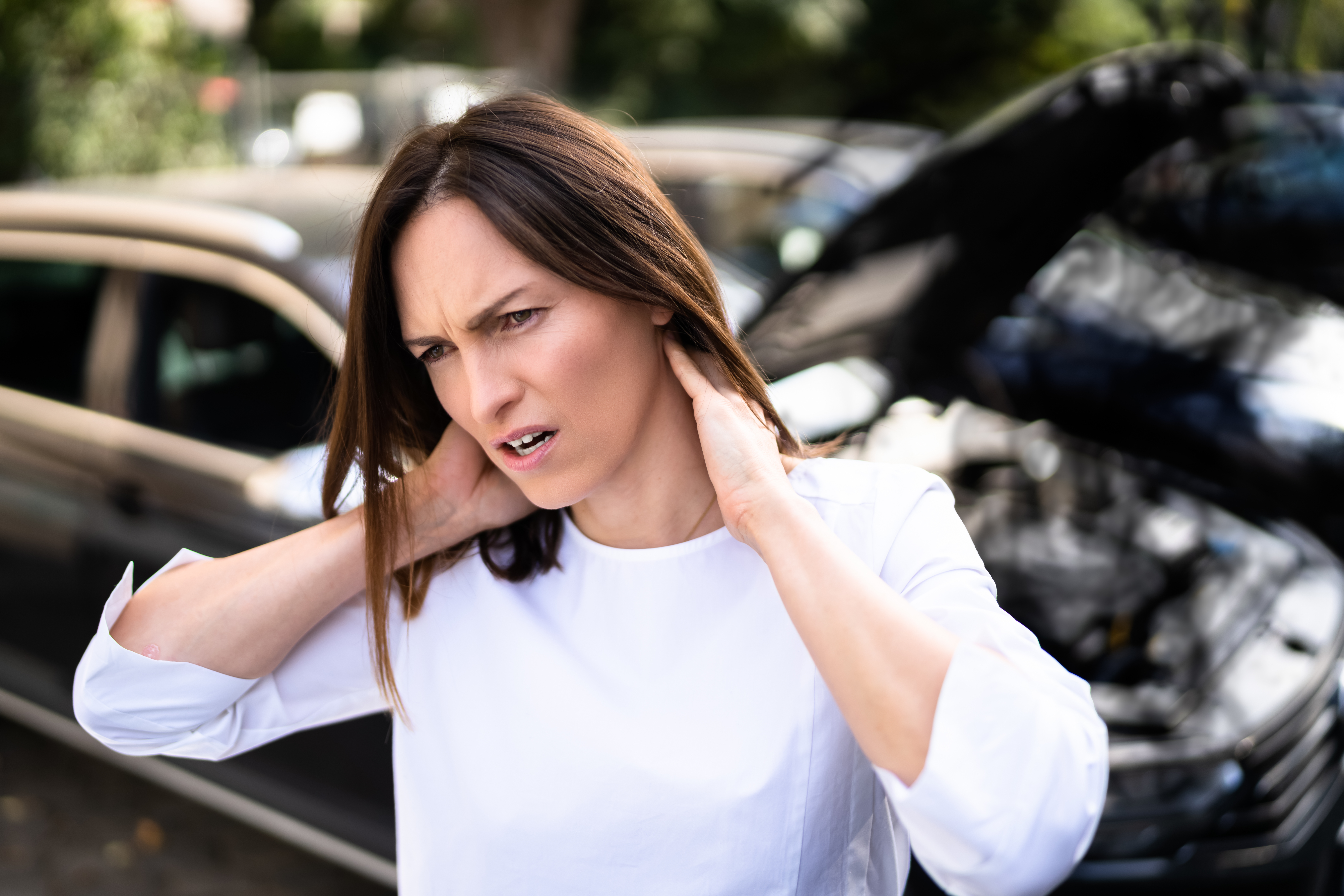 Woman with neck pain after car accident — TMJ PIP coverage