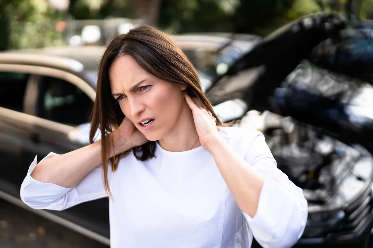 Woman with neck pain after car accident — TMJ PIP coverage